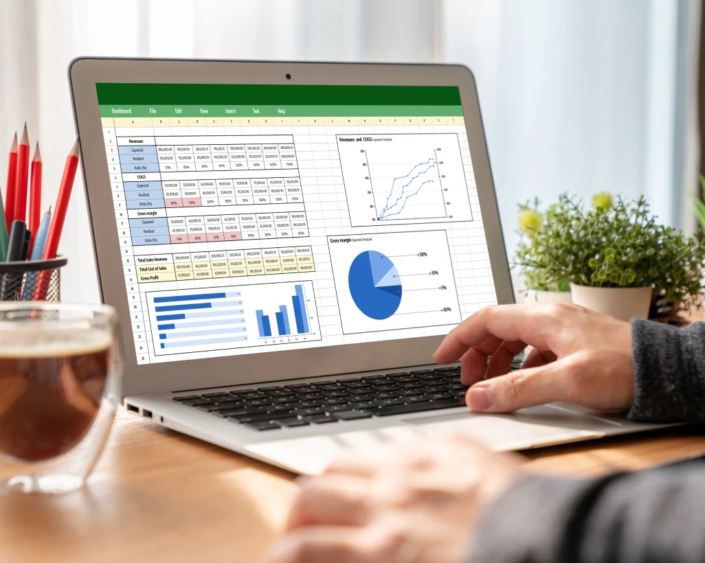Business analytics and spreadsheet dashboard on a laptop